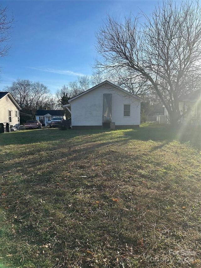 view of side of property with a yard