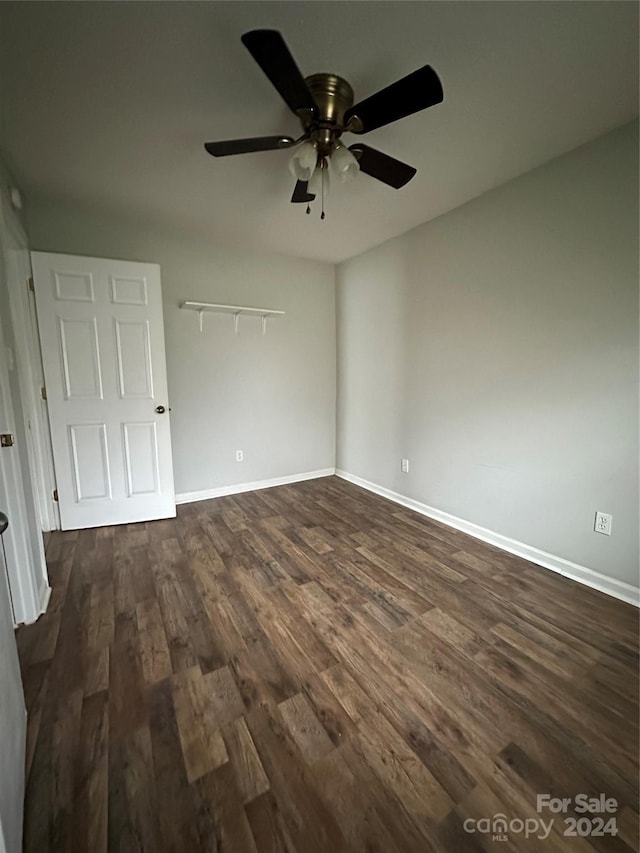 unfurnished bedroom with ceiling fan and dark hardwood / wood-style flooring