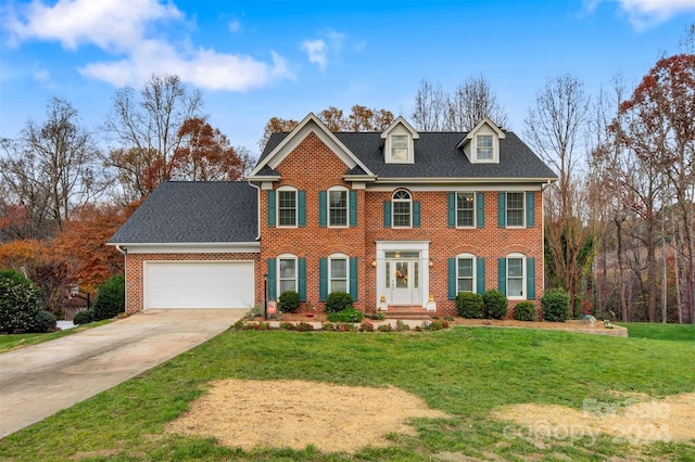 colonial inspired home with a front lawn