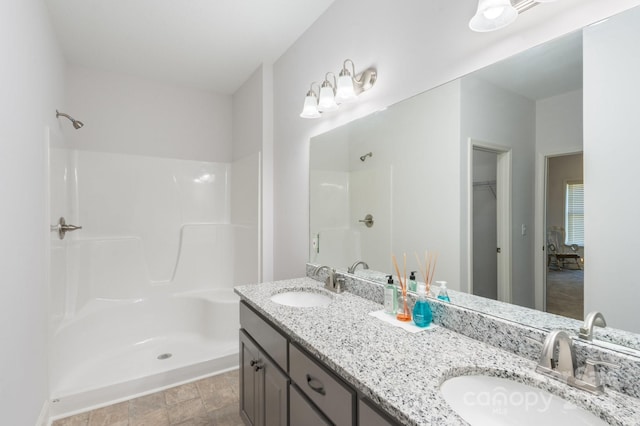 bathroom with vanity and a shower