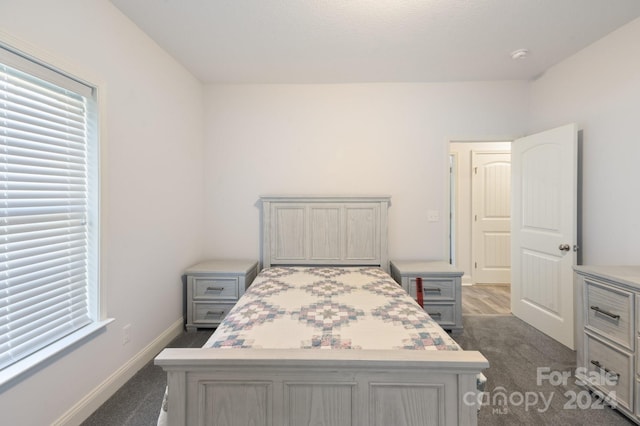 bedroom featuring dark carpet