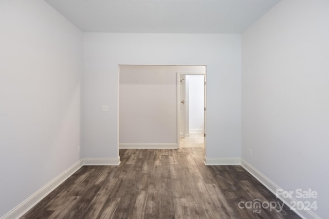 spare room with dark wood-type flooring