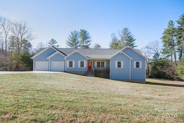 ranch-style house featuring covered porch, a garage, and a front lawn