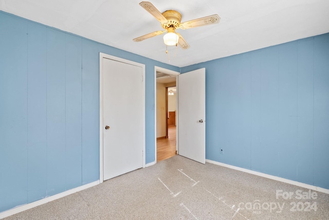 unfurnished bedroom with carpet and ceiling fan