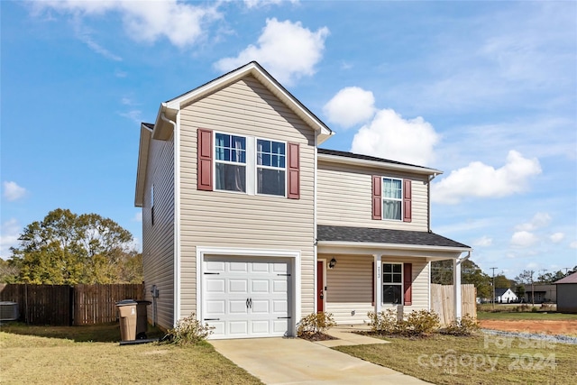 view of front property featuring a garage, central air condition unit, and a front yard