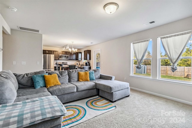 living room featuring a notable chandelier and light carpet