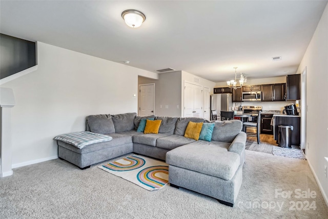 living room with light colored carpet and an inviting chandelier