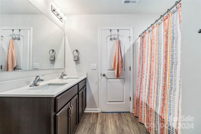 bathroom with vanity and wood-type flooring