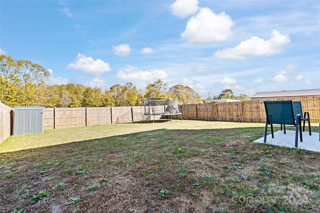 view of yard featuring a trampoline and a patio area