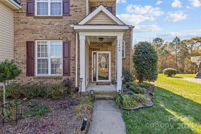 doorway to property featuring a yard