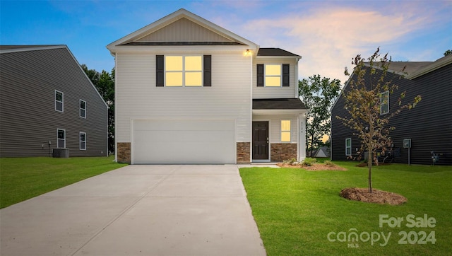 craftsman-style home with a garage and a yard