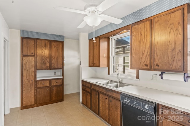 kitchen featuring light countertops, black dishwasher, brown cabinets, and a sink