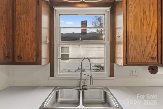 kitchen with light countertops and a sink