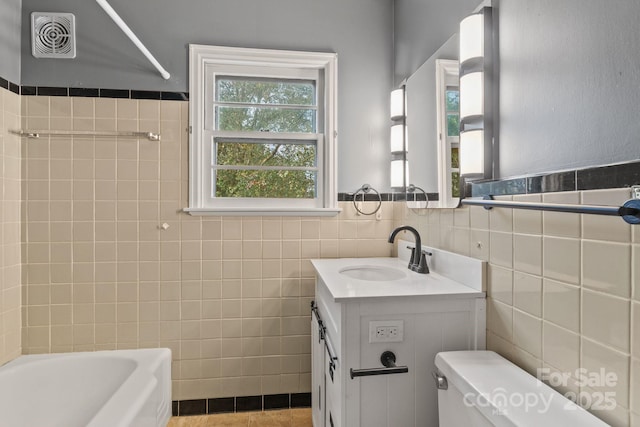 bathroom featuring visible vents, tile walls, toilet, shower / bathing tub combination, and vanity