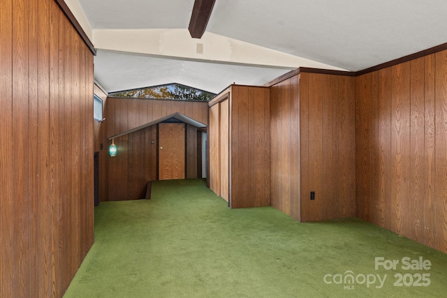 corridor featuring lofted ceiling with beams, carpet, and wood walls