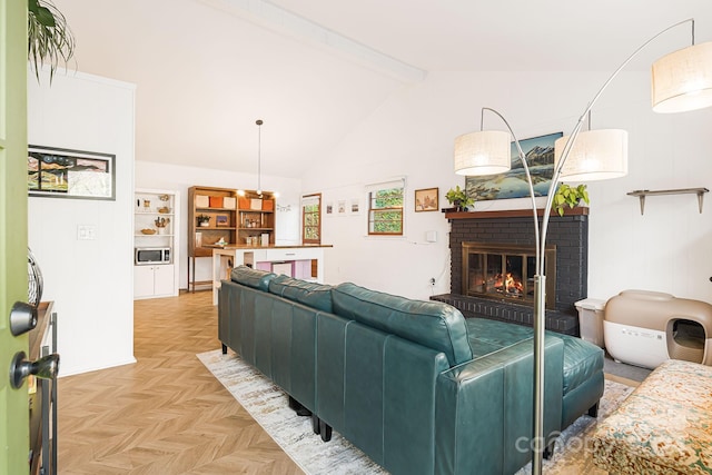 living room with a fireplace, light parquet flooring, and lofted ceiling with beams