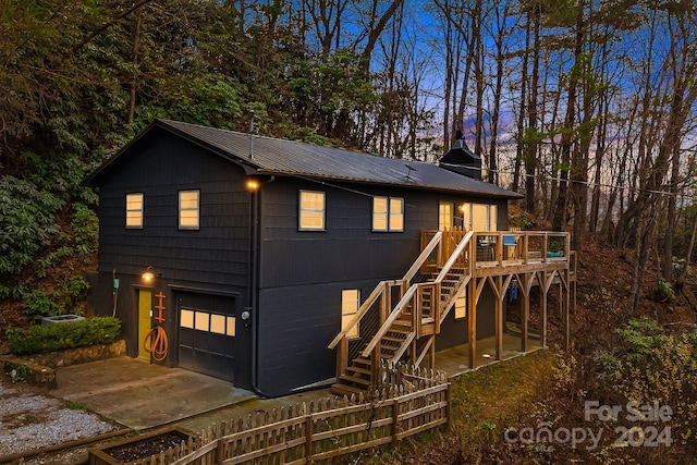 view of front of home with a garage and a wooden deck