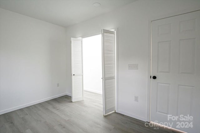 unfurnished bedroom with light wood-type flooring