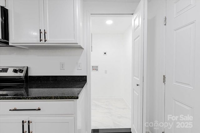 kitchen with white cabinetry, dark stone counters, recessed lighting, and marble finish floor