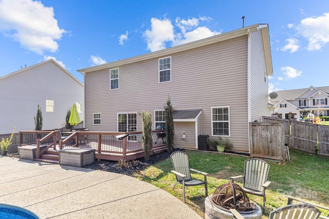 back of house with a patio area, a deck, and a fire pit