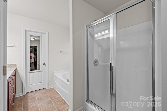 bathroom with tile patterned floors, vanity, and independent shower and bath