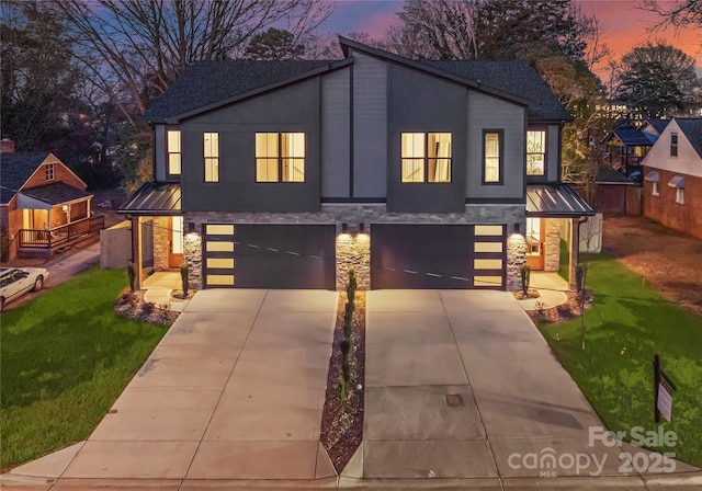 view of front of property with a lawn and a garage