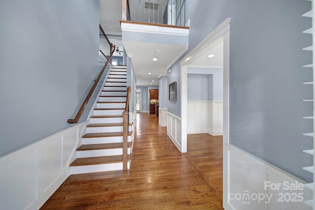 entrance foyer featuring wood-type flooring and crown molding