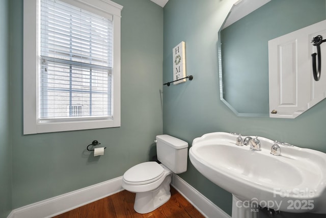 bathroom with sink, hardwood / wood-style flooring, and toilet