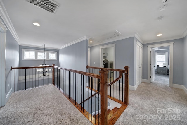 hall featuring separate washer and dryer, a wealth of natural light, and light colored carpet