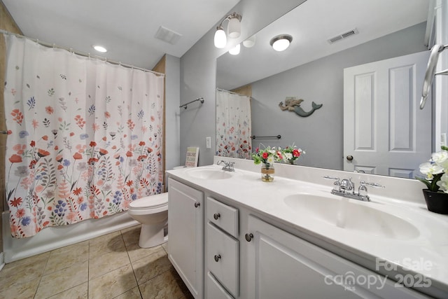 full bathroom featuring shower / bath combo with shower curtain, tile patterned floors, toilet, and vanity