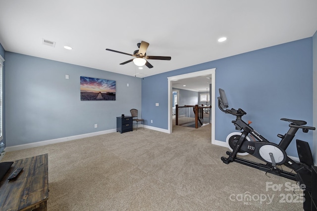 exercise room featuring light colored carpet and ceiling fan