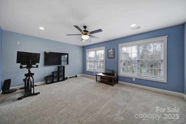 workout area with ceiling fan and carpet flooring