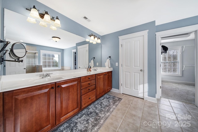 bathroom with vanity, a shower with door, and tile patterned flooring