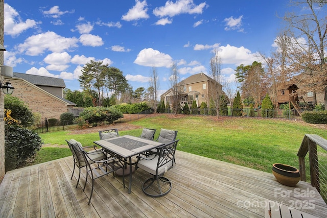 wooden deck featuring a lawn