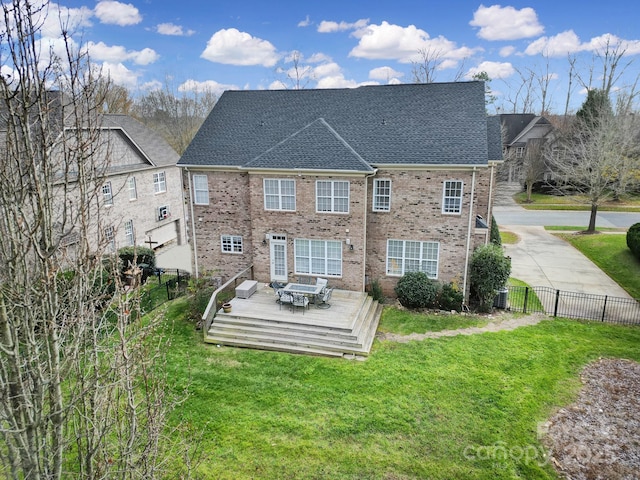 back of property with a lawn and a deck