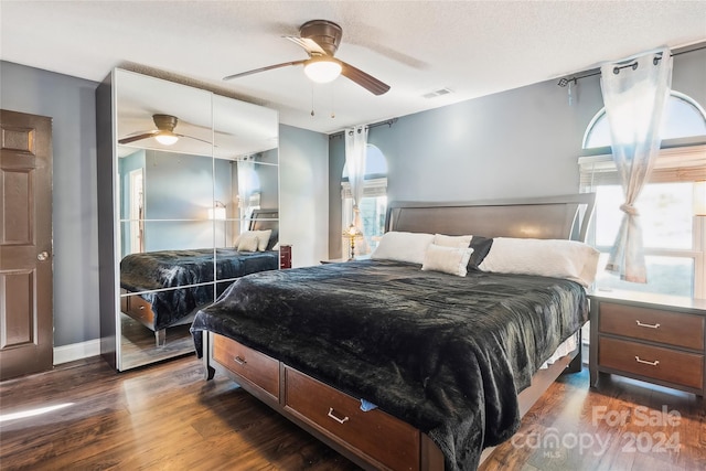 bedroom with ceiling fan and dark wood-type flooring