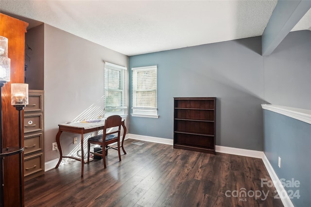 office space with dark wood-type flooring and a textured ceiling