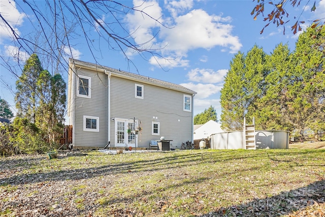 rear view of property with a lawn