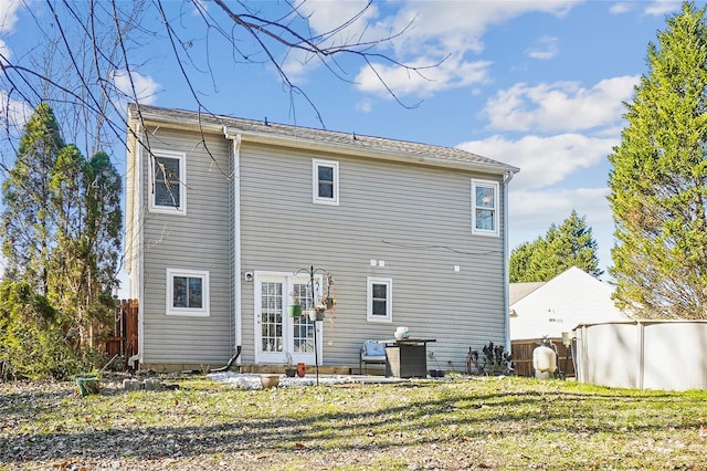 rear view of house featuring a lawn and a patio