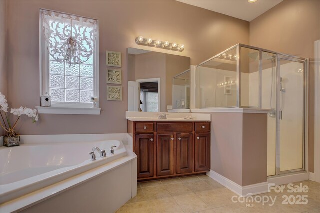 bathroom featuring a stall shower, tile patterned floors, vanity, and a bath