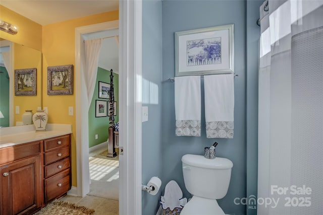 bathroom featuring vanity and toilet