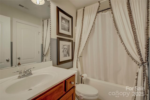 bathroom featuring toilet, visible vents, shower / bath combination with curtain, and vanity