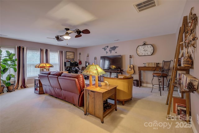 living area with light colored carpet, visible vents, ceiling fan, and baseboards