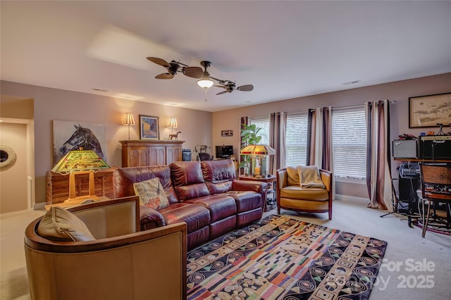 living room with visible vents, a ceiling fan, and light colored carpet