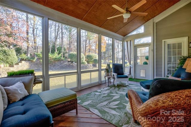 sunroom featuring lofted ceiling, wood ceiling, ceiling fan, and a wealth of natural light