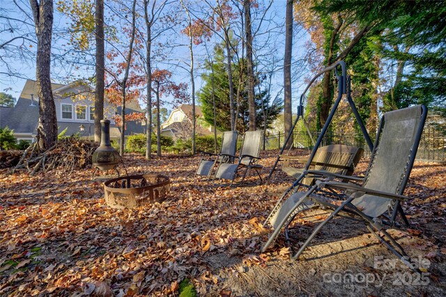 view of yard featuring fence and a fire pit