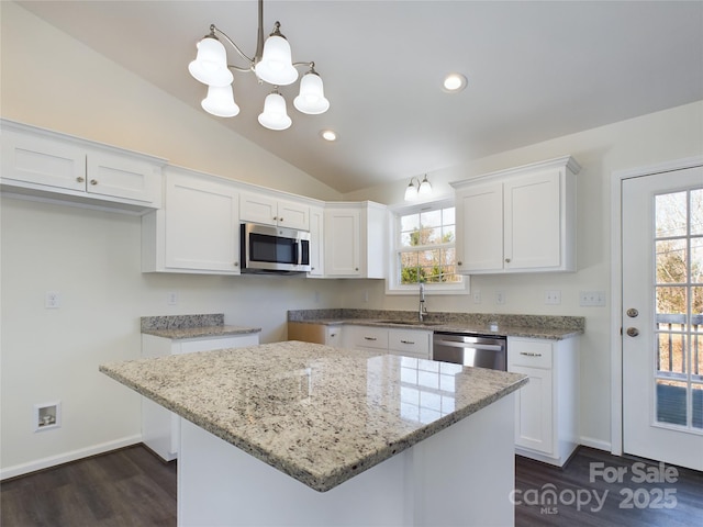 kitchen featuring white cabinets, pendant lighting, and appliances with stainless steel finishes