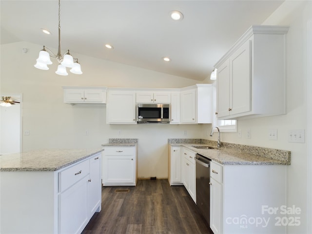 kitchen with white cabinetry, sink, lofted ceiling, ceiling fan with notable chandelier, and appliances with stainless steel finishes