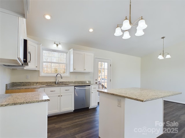 kitchen featuring white cabinets, a center island, and stainless steel dishwasher