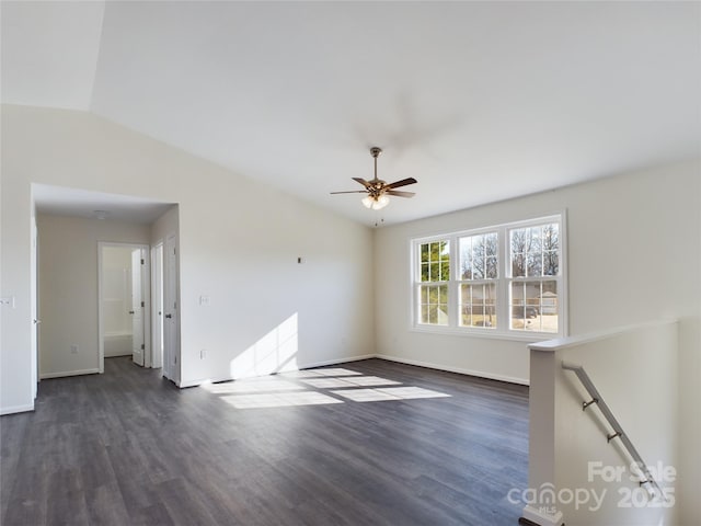 unfurnished living room with vaulted ceiling, ceiling fan, and dark wood-type flooring